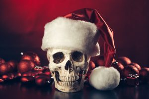 Christmas-A-Season-of-Cheer-Skull wearing a Santa hat: "With Santa Claus," a festive murder mystery with dark humor.